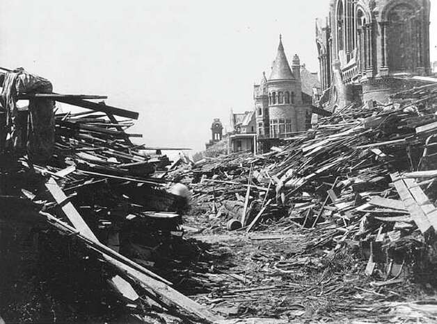 The Gresham house, center, now known as the Bishop's Palace, sits relatively unscathed behind a wall of debris following the hurricane that devastated Galveston, Texas, Sept. 8, 1900. More than 6,000 people were killed and 10,000 left homeless as entire neighborhoods were swept clean. Heavily damaged Sacred Heart Catholic Church is at right. (AP Photo/Sisters of Charity of the Incarnate Word)