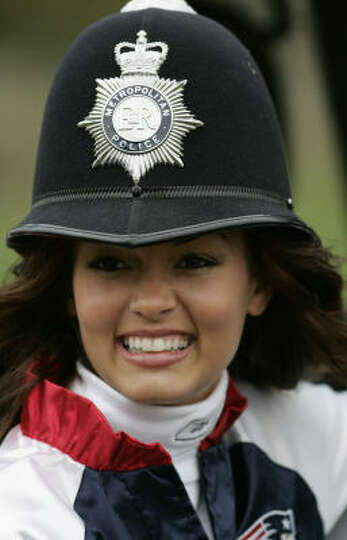 New England Patriots cheerleader Sara Caldeira poses with a British police officers&#39; helmet. - 960x540