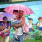 A father carries his daughter after the approaching Typhoon Nesat.... photo: 1630349 slideshow 31095