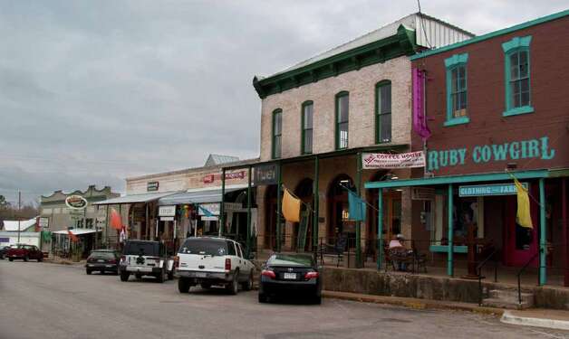 mix of storefronts from cowboythemed clothing to modern coffeehouses