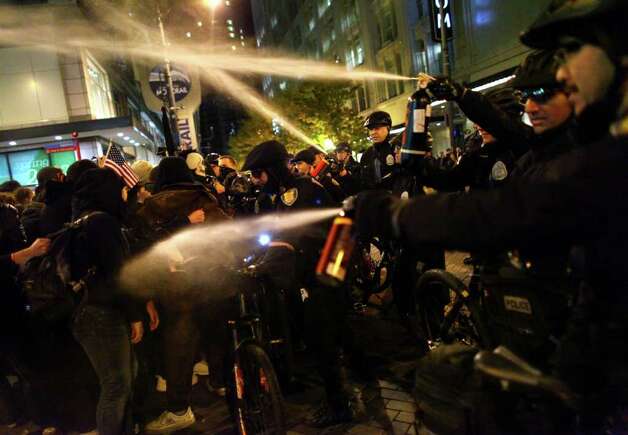 Seattle Police officers deploy pepper spray into a crowd during an Occupy Seattle protest on Tuesday, November 15, 2011 at Westlake Park. Photo: JOSHUA TRUJILLO / SEATTLEPI.COM