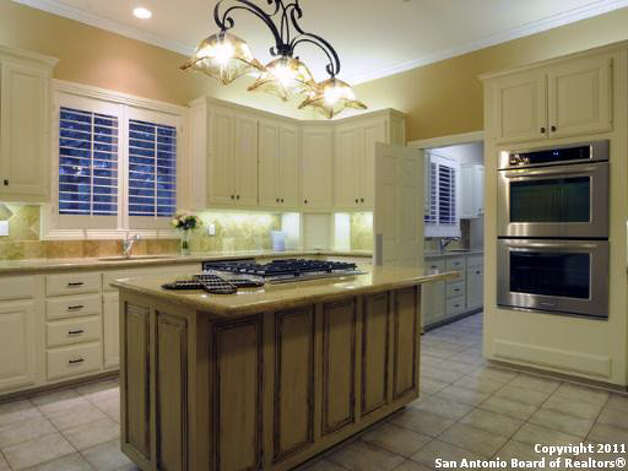 A more expansive look at the kitchen, highlighting the stove, ovens and center island. Photo: Realtor.com / SA