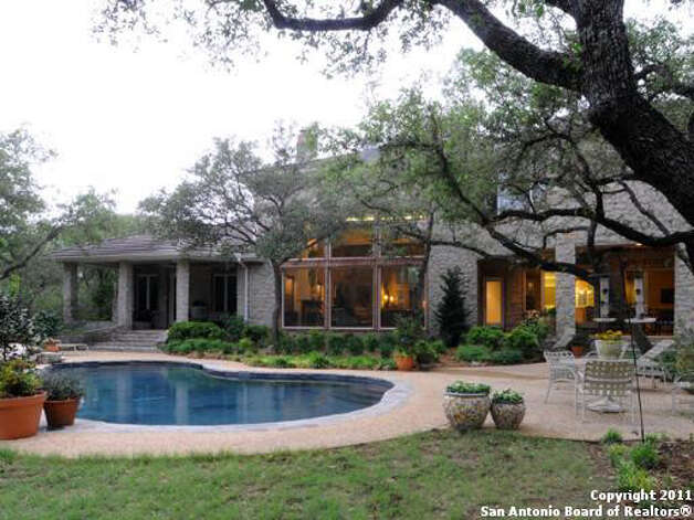 Another look at the back yard of the property, spotlighting the swimming pool and patio. Photo: Realtor.com / SA