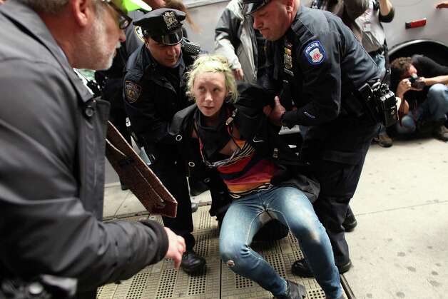 NEW YORK, NY - MAY 01:  A protester associated with the Occupy Wall Street movement is arrested while marching through traffic in lower Manhattan on May 1, 2012 in New York City. May 1st, Labor Day, is a traditional day of global protest in sympathy with union and leftist politics. Photo: Spencer Platt, Getty Images / 2012 Getty Images