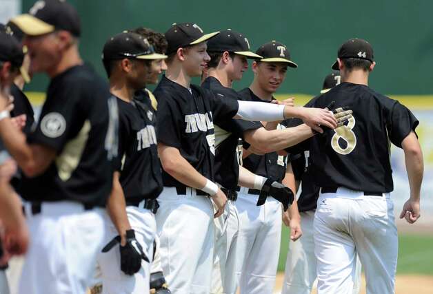 Trumbull's Colin Keyes gets fist bumps and pats on the back as his team is introduced during Saturday's FCIAC baseball championship game against Greenwich at the Ballpark at Harbor Yard in Bridgeport on May 26, 2012. Photo: Lindsay Niegelberg / Stamford Advocate