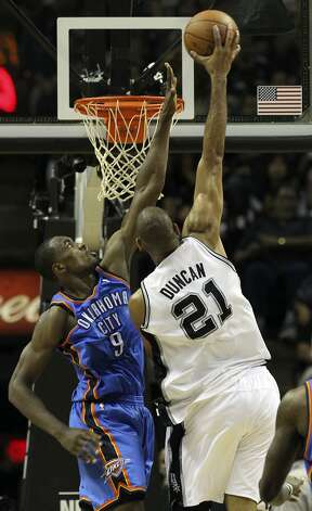 San Antonio Spurs' Tim Duncan (21) dunks against Oklahoma City Thunder's Serge Ibaka (9) during the first half of game two of the NBA Western Conference Finals in San Antonio, Texas on Tuesday, May 29, 2012. Kin Man Hui/Express-News (Kin Man Hui / San Antonio Express-News) / SA