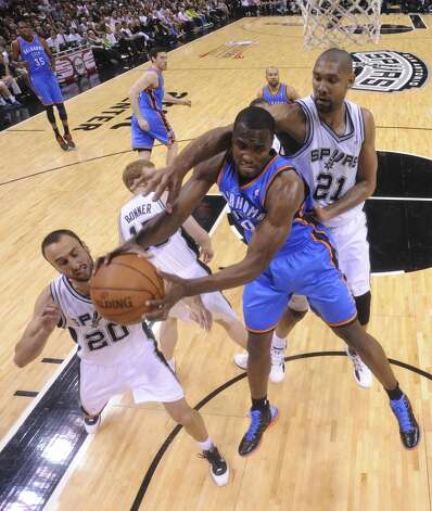 Oklahoma City Thunder's Serge Ibaka (9) is pressured by San Antonio Spurs' Manu Ginobili (20) and San Antonio Spurs' Tim Duncan (21) during the first half of game two of the NBA Western Conference Finals in San Antonio, Texas on Tuesday, May 29, 2012. Edward A. Ornelas/Express-News (Edward A. Ornelas / San Antonio Express-News) / SA