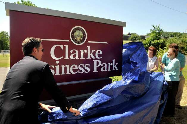 Brendan McCollam, left, and Kate Clarke Bush, second from right, unveil the sign rededicating the Francis J. Clarke Industrial Park as the Clarke Business Park in Bethel Thursday, June 28, 2012. Rose Ann Clarke, 79, looks on. Photo: Michael Duffy / The News-Times