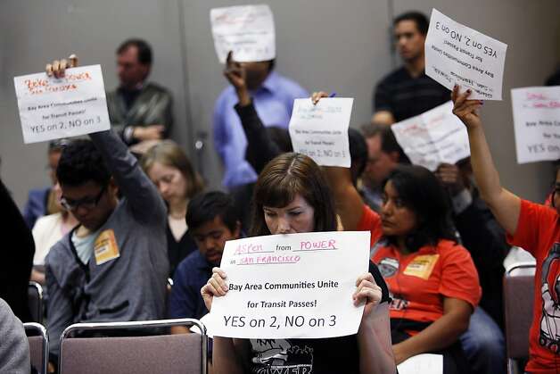 Aspen Dominguec, center, holds up a sign during the MTC's meeting in Oakland on Wednesday. Photo: Sonja Och, The Chronicle / SF