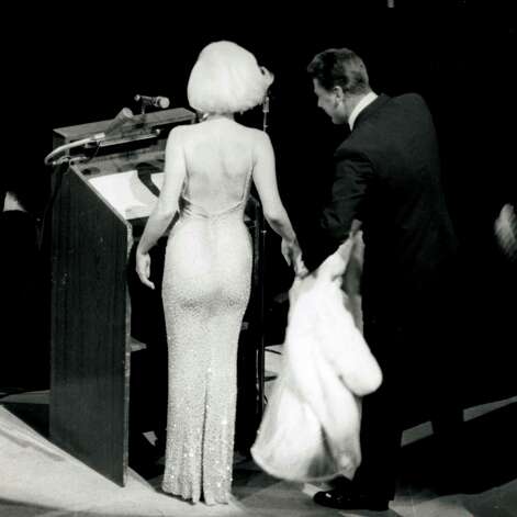 Marilyn Monroe takes to the stage at Madison Square Garden to sing "Happy Birthday" to Presideint John F. Kennedy who was turning 45 in 1962. Peter Lawford tends to Monroe's fur wrap. She was the last act of the evening that included performances from Maria Callas, Jack Benny, Peggy Lee, Harry Belafonte and Shirley MacLaine. "There was a hush over the whole place when I came on to sing," Monroe told Life magazine two months later. "Like if I had been wearing a slip I would have thought it was showing or something. I thought, 'Oh, my gosh, what if no sound comes out?!" Monroe's dress, designed by Jean Louis was flesh-hued and sheer and covered with 4,000 rhinestones. She paid Louis $5,000 to create the "historic" dress. Photo: New Marilyn Monroe / HC