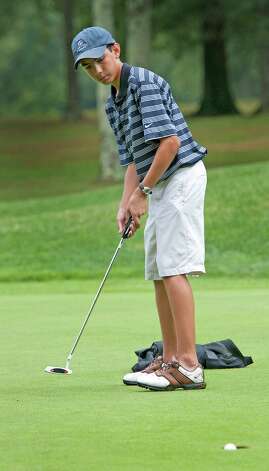 Playing in the boys 14 to 17 year old division Kenny Dorian makes a putt on the 18th green in the Greenwich Townwide Jr. golf championships held at Griffith E. Harris golf course, Greenwich, CT on Wednesdy August 15th, 2012. Photo: Mark Conrad / Stamford Advocate Freelance