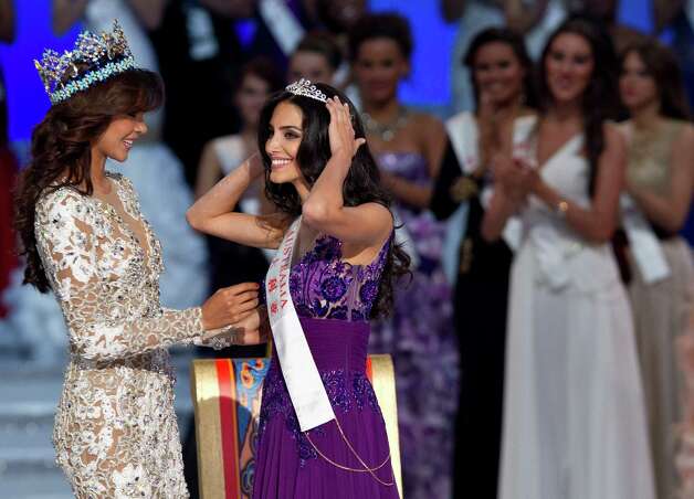 Runner-up Miss Australia Jessica Kahawaty, right, smiles after she was crowned by Miss World 2011 Ivian Lunasol Sarcos Colmenares of Venezuela. Photo: AP / SL