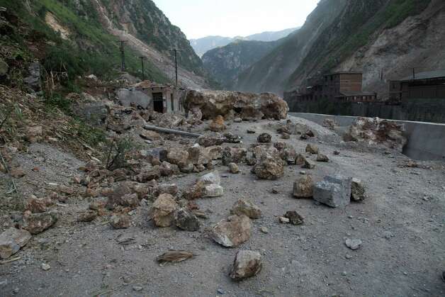 A rock-fall blocks a road in Yiliang, southwest China's Yunnan province on Friday, following two shallow quakes that struck the remote and mountainous border area of Yunnan and Guizhou province of southwest China.   Dozens of people were killed and 550 injured when two shallow quakes with a magnitude of both at 5.6 struck a remote and mountainous area of southwest China, toppling buildings and sparking chaos in the streets, officials said. ( AFP/AFP/GettyImages) Photo: AFP, Ap/getty / 2012 AFP
