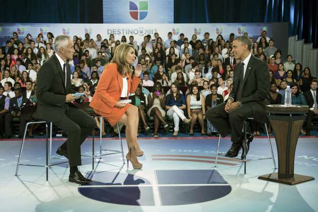 Hosts Jorge Ramos (L) and Maria Elena Salinas (C) sit with US President Barack Obama during a break in a taping of Univision News's "Meet the Candidates" at the University of Miami September 20, 2012 in Coral Gables, Florida.  Obama is traveling to Florida for the day to participate in a taping for Univision in Miami before attending a campaign event in Tampa.  AFP PHOTO/Brendan SMIALOWSKIBRENDAN SMIALOWSKI/AFP/GettyImages Photo: BRENDAN SMIALOWSKI, AFP/Getty Images / 2012 Brendan Smialowski