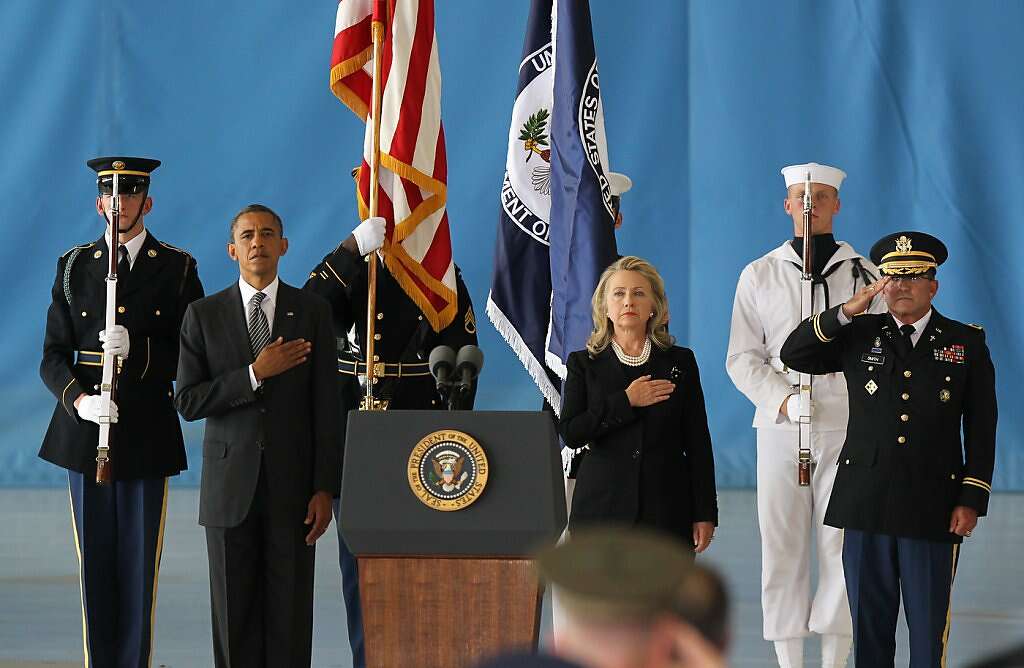 JOINT BASE ANDREWS, MD - SEPTEMBER 14:  U.S. President Barack Obama (2nd L) and U.S. Secretary of State Hillary Clinton (3rd R) hold their hands over their hearts during the Transfer of Remains Ceremony for the return of Ambassador Christopher Stevens and three other Libyan embassy employees at Joint Base Andrews September 14. 2012 in Joint Base Andrews, Maryland. Stevens and the three other embassy employees were killed when the consulate in Libya was attacked September 11.   (Photo by Molly Riley-Pool/Getty Images) *** BESTPIX *** Photo: Pool, Getty Images