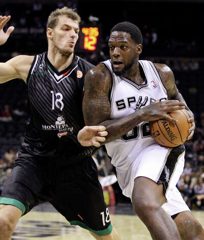 The Spurs' Eddy Curry looks for room around Montepaschi Siena's Luca Lechthaler during second half action Saturday, Oct. 6, 2012, at the AT&T Center. The Spurs won 106-77. Photo: Edward A. Ornelas, San Antonio Express-News / ? 2012 San Antonio Express-News