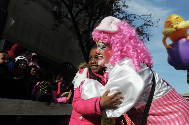 Sanaayh Dotson, 8, gets a hug from a Cirque-tacular clown, played by Barbara Occhino, during the UBS Parade Spectacular in Stamford, Conn., Nov. 18, 2012. Photo: Keelin Daly / Stamford Advocate Freelance