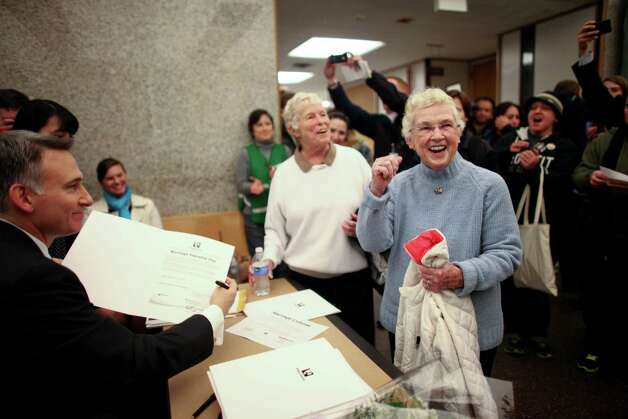 Jane Abbott Lightly and her partner Pete-e Petersen, right, celebrate as King County Executive Dow Constantine signs their marriage license at the King County Administration Building on Wednesday, December 5, 2012. Photo: JOSHUA TRUJILLO / SEATTLEPI.COM