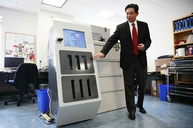 Michael Liang, chief information officer of the S.F. Public Library, hopes the electronic kiosks will double the number of laptops available to patrons. The machines dispense a laptop with a swipe of a library card. Photo: Lea Suzuki, The Chronicle