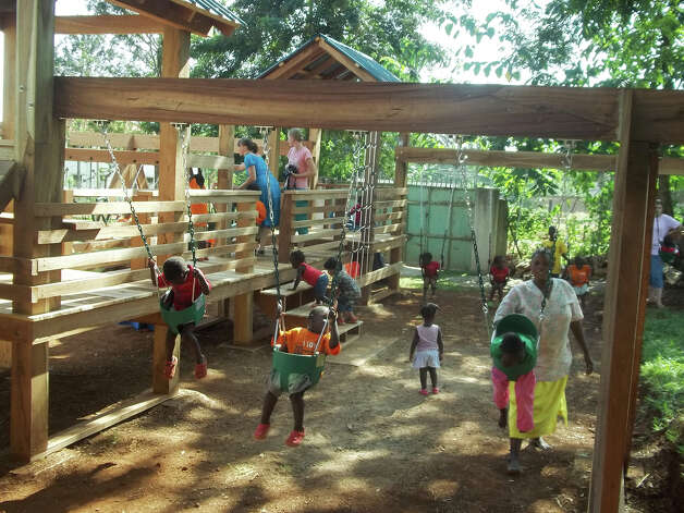 Children of the Amani Baby Cottage in Uganda play on their new playgorund. Photo: Contributed Photo
