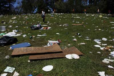 Workers clear trash from a section of Golden Gate Park known as Hippie Hill after an annual pot-smoking party. Photo: James Tensuan, The Chronicle