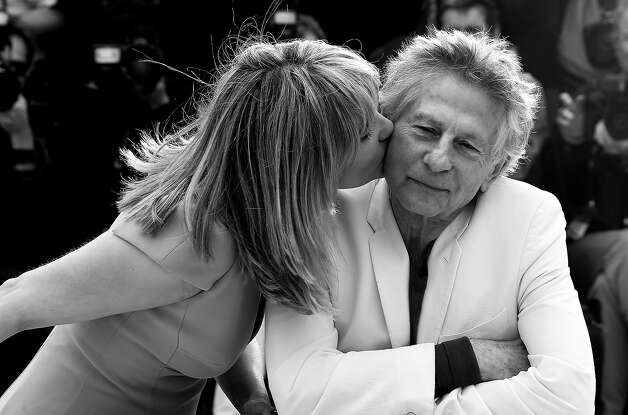 French actress Emmanuelle Seigner (L) kisses on May 25, 2013 her husband, director Roman Polanski during a photocall for the film "Venus in Fur" presented in Competition at the 66th edition of the Cannes Film Festival in Cannes. Cannes, one of the world's top film festivals, opened on May 15 and will climax on May 26 with awards selected by a jury headed this year by Hollywood legend Steven Spielberg. Photo: VALERY HACHE, AFP/Getty Images / 2013 AFP