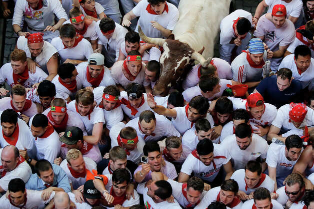 Steers make their way through a crowd of runners after the Alcurrucen's ranch fighting bulls entered the bullring during the second day of the San Fermin Running Of The Bulls festival on July 7, 2013 in Pamplona, Spain. The annual Fiesta de San Fermin, made famous by the 1926 novel of US writer Ernest Hemmingway 'The Sun Also Rises', involves the running of the bulls through the historic heart of Pamplona, this year for nine days from July 6-14. Photo: Pablo Blazquez Dominguez, Getty Images / 2013 Getty Images