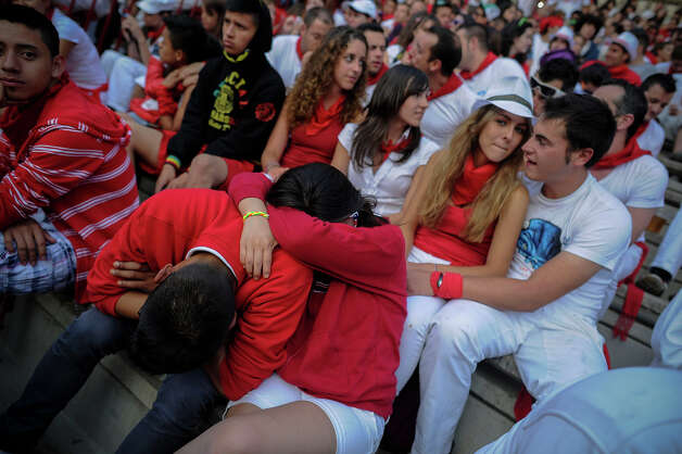 A couple sleep as they wait for the second bull run of the San Fermin Festival in Pamplona, northern Spain, on July 8, 2013. The festival is a symbol of Spanish culture that attracts thousands of tourists to watch the bull runs despite heavy condemnation from animal rights groups. Photo: PEDRO ARMESTRE, AFP/Getty Images / 2013 AFP