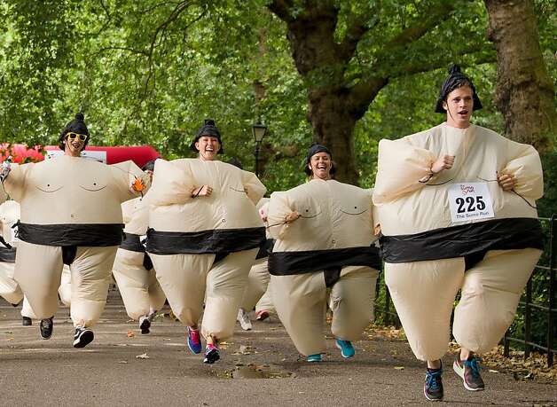 Tons of fun: While a Guinness Record for most people running in inflatable sumo suits exists, the racers 

in the annual 5k charity Sumo Run at Battesea Park, London, were not trying to break it 

this year. The satisfaction of 

competing in fat suits and diapers was reward enough. Photo: Leon Neal, AFP/Getty Images