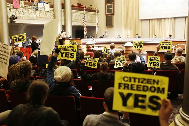 Protestors against the Domain Awareness Center hold up signs during a city council meeting at the Oakland City Hall in Oakland, Calif. on July 30, 2013. Photo: Ian C. Bates, The Chronicle