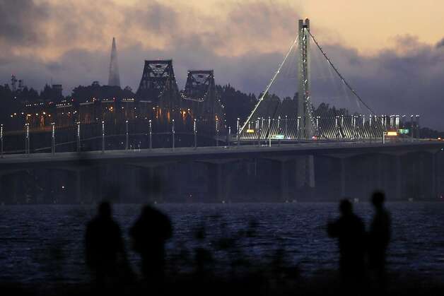 Drivers wait along Powell Street in Emeryville, Calif., for the new eastern span of the Bay Bridge to open on Monday evening. They were rewarded  shortly after 10pm Monday September 2, 2013 as the bridge was opened hours ahead of schedule. Photo: Carlos Avila Gonzalez, The Chronicle