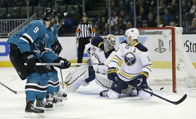 Marty Havlat (left) got the Sharks on the scoreboard first with a backhander that slipped under Sabres goalie Ryan Miller. Photo: Marcio Jose Sanchez, Associated Press