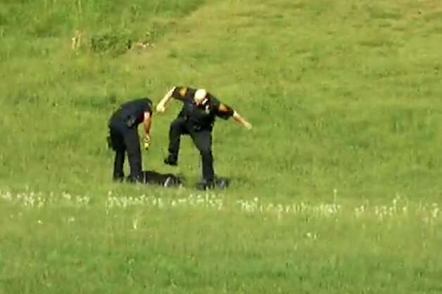 A screen grab from a video, posted on YouTube on Jan. 6, 2013, showing three Bridgeport, Conn. police officers kicking a man in Beardsley Park on May 20, 2011. Officers Elson Morales, Joseph Lawlor  and Clive Higgins were put on the paid administrative leave Jan.18, 2013 pending an investigation of the incident by the city's Office of Internal Affairs. The man, who has not been identified, is lying on the ground after being Tasered by one of the officers when two of the officers begin kicking him. A third officer then gets out of his patrol car and walks over to where the other two are still kicking the man and then he too begins kicking him. Photo: Contributed Photo / Connecticut Post Contributed