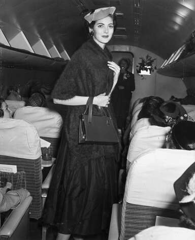 American model Carmen Dell'Orefice while walking in the aisle of an airplane during a fashion show, circa 1955. Photo: Hulton Archive, Getty Images