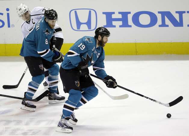 San Jose Sharks' Joe Thornton (19) controls the puck in front of teammate Joe Pavelski (8) and Los Angeles Kings right wing Dustin Brown (23) looks on during the first period of an NHL hockey game on Monday, Jan. 27, 2014, in San Jose, Calif. (AP Photo/Marcio Jose Sanchez) Photo: Marcio Jose Sanchez, Associated Press