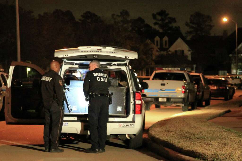 Officers work the scene in the 14000 block of Fosters Creek in northwest Harris County where sheriff's deputies said  four people were found dead at a home on Thursday, Jan. 30, 2014, in Houston. Photo: Karen Warren, Houston Chronicle / © 2014  Houston Chronicle