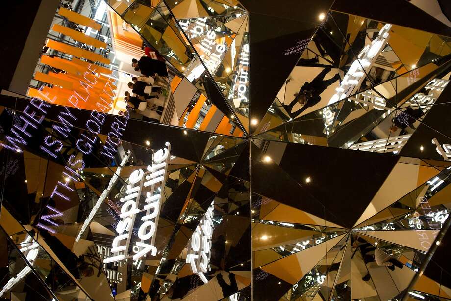 Kaleidoscopic mirrors reflect slogans and fair visitors at the stand of German software giant SAP at the 2014 CeBIT computer technology trade fair on March 10, 2014 in Hanover, central Germany. Photo: John Macdougall, AFP/Getty Images