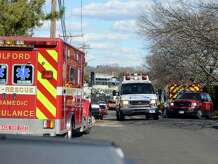 Emergency crews set up a staging area for their rescue of two people from the Long Island Sound Saturday, Mar. 15, 2014, at the Milford Yacht Club on Trumbull Avenue in Milford, Conn. The boaters were taken to Milford Hospital for treatment after they were pulled from the water.