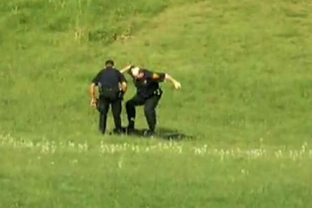 A screen grab from a video, posted on YouTube on Jan. 6, 2013, showing three Bridgeport, Conn. police officers kicking a man in Beardsley Park on May 20, 2011. On Tuesday, May 27, 2014 city officials said they agreed to settle the man's civil rights lawsuit against the Police Department, paying him $198,000. Photo: Contributed Photo / Connecticut Post Contributed