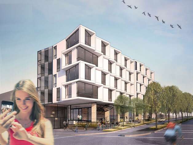 Now a parking lot, the southeast corner of Octavia Boulevard and Page Street has been awarded to a development team that plans to build 26 condominums, four of theme affordable, along street-level retail spaces. Photo: Edmonds + Lee