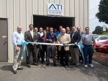 First Selectman George Temple and State Sen. Robert Kane hold the ribbon as it is cut by Autonomy Technology officials marking their move to Oxford July 2.