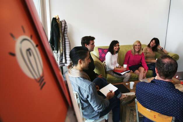 Near Me employees hold their meeting at Makeshift Society in the Hayes Valley area on July 16, 2014 in San Francisco, CA. Near Me is a startup company with a "just add water" platform for companies that want to be the "Airbnb of X." Once a month, for a change of scenery, Near Me rents a bigger office space. Photo: Craig Hudson, The Chronicle