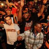 Giants fans on Valencia St. celebrate their team's victory in the 2014 World Series on Wednesday, Oct. 29, 2014.