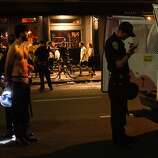 A man is detained near AT&amp;T Park during the celebration following the Giants' victory in the 2014 World Series on Wednesday, Oct. 29, 2014.