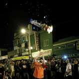 A man throws an effigy of a Royals player into the air near the intersection of 19th and Mission Street after the Giants win the World Series on Wednesday, October 29, 2014.