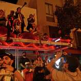 Giants fans climb a Muni bus stop during riots in the streets near 22nd and Mission after the San Francisco Giants win the World Series against the Kansas City Royals Wednesday, October 29, 2014.