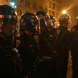 Riot police take position in the streets near 22nd and Mission during a riot after the San Francisco Giants win the World Series against the Kansas City Royals Wednesday, October 29, 2014.