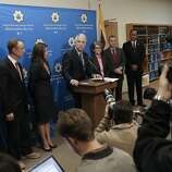 San Francisco District Attorney George Gascon, (center) announces a civil consumer protection action against transportation network company Uber, for making false or misleading statements to consumers and for engaging in a variety of business practices which violate California law, during a press conference at the Hall of Justice in San Francisco, Calif. on Tuesday Dec. 9, 2014.