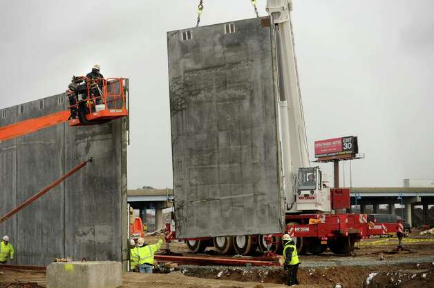 Prefabricated concrete walls are lifted into position during the start of vertical construction on the new Bass Pro Shops on Steel Point in Bridgeport, Conn. on Thursday, December 11, 2014. Photo: Brian A. Pounds / Connecticut Post