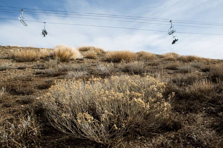 Skiers ride a chairlift over dry ground at Squaw Valley Ski Resort on Saturday, March 21, 2015, in Olympic Valley, Calif. Photo: Max Whittaker, Getty